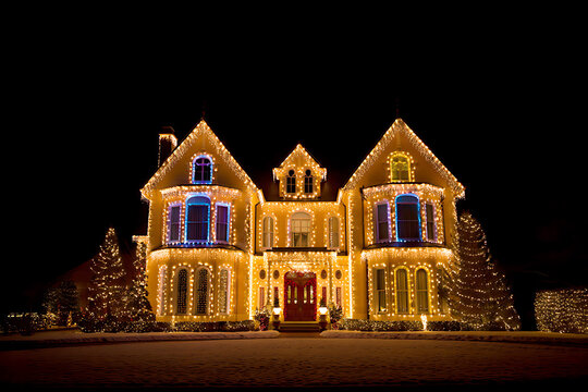 Large house decorated with Christmas lights at night