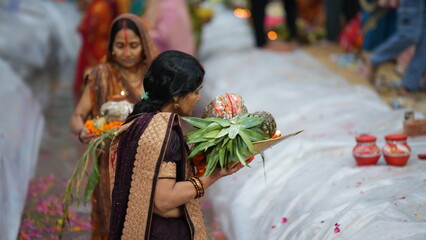 Women in Bihar offer arghya to the setting Sun during Chhath Puja, standing in the river with devotion. 
