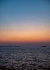 Serene Ocean Sunset with Distant Islands