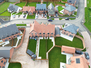 Newly built semi detached and terraced affordable homes seen on a Greenfield housing development site in rural Essex, UK. Note the newly laid lush lawns.