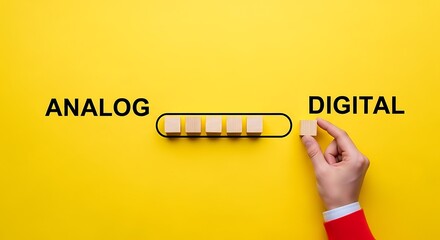Hand converts analog to digital with wooden blocks on yellow background