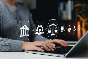 Law and Justice Concept. Legal professional using latop with icons symbolizing law, justice, legal services. lawyer, business legislation, notary public, law firm, online legal advice, practice of law