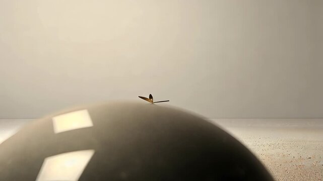 Shiny golden objects reflect light while interacting with smooth surfaces in an artistic exploration of shapes and textures