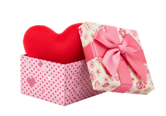 A red heart shaped pillow inside an open gift box with a pink bow