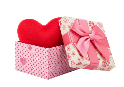 A red heart shaped pillow inside an open gift box with a pink bow