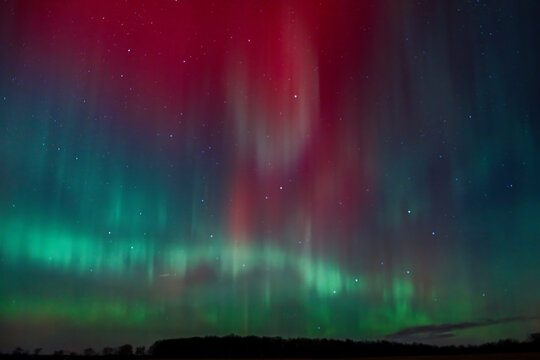 Aurora Borealis over St. Croix County, Wisconsin on November 11, 2025. Red and green northern lights illuminate the night sky with the Big Dipper and North Star visible above the horizon.