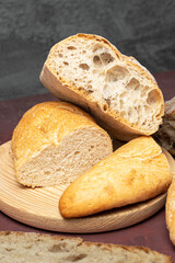 Rustic loaves of sliced bread on a cutting board, highlighting texture and crust