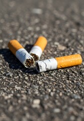 Anti-smoking awareness concept with cigarette butts on asphalt background highlighting environmental impact and health consciousness