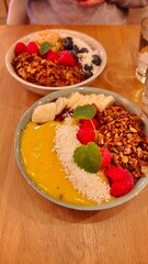 Colourful and delicious acai fruity breakfast bowl with toppings