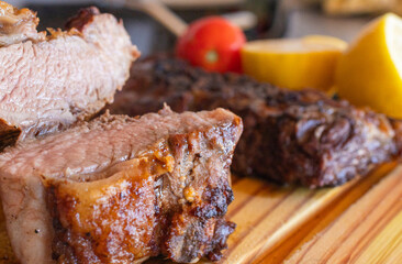 Close-up photo of a grilled chorizo steak on a rustic wooden board, fresh meat served hot and just prepared.
