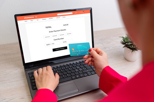 Woman entering credit card details on laptop for online payment, concept of secure checkout, e-commerce transaction, and digital financial technology