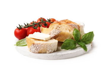Slices of baguette with butter, basil and tomatoes isolated on white