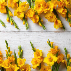 Yellow gladiolus flowers arranged white wooden surface with bright