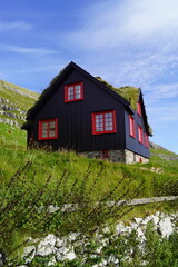 Traditional old houses with grass on the roof and painted black with tar on the Faroe Islands