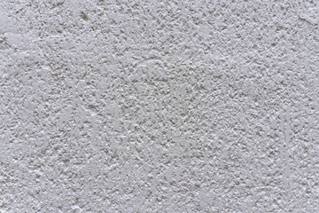 A close-up of a wall with textured decorative plaster in an abstract relief. Background. Texture.