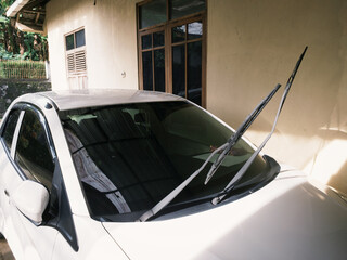 Car's glass wipers lifted for cleaning after exposed to rain