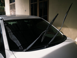 Car's glass wipers lifted for cleaning after exposed to rain