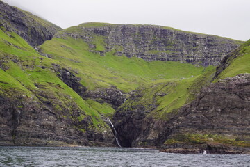 The steep and dramatic coastline around the Vestmanna Cliffs in the Atlantic Ocean off the Faroe Islands © ChrisOvergaard