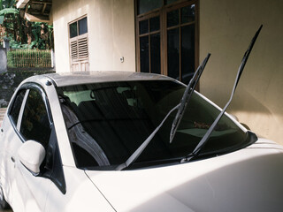 Car's glass wipers lifted for cleaning after exposed to rain