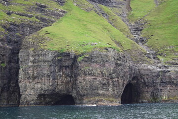 The steep and dramatic coastline around the Vestmanna Cliffs in the Atlantic Ocean off the Faroe Islands © ChrisOvergaard