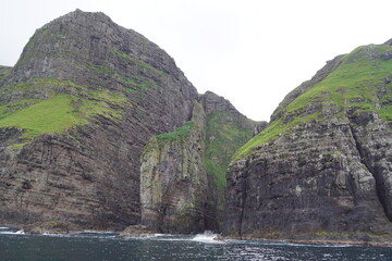 The steep and dramatic coastline around the Vestmanna Cliffs in the Atlantic Ocean off the Faroe Islands © ChrisOvergaard