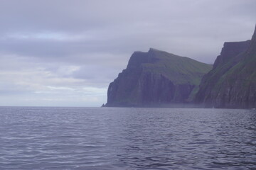 The steep and dramatic coastline around the Vestmanna Cliffs in the Atlantic Ocean off the Faroe Islands © ChrisOvergaard