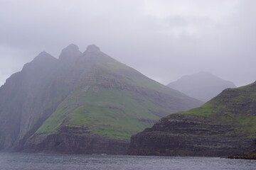 The steep and dramatic coastline around the Vestmanna Cliffs in the Atlantic Ocean off the Faroe Islands © ChrisOvergaard