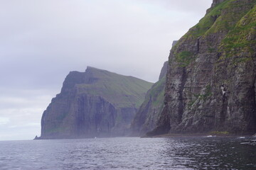 The steep and dramatic coastline around the Vestmanna Cliffs in the Atlantic Ocean off the Faroe Islands © ChrisOvergaard
