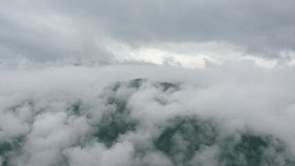 Alpine granite mountain peak covered in mist and clouds. La Vanoise national park, Savoie, France 