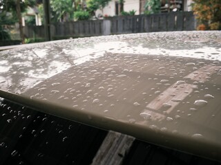 Close up car exterior part exposed with rain water droplets