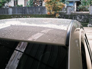 Close up car exterior part exposed with rain water droplets