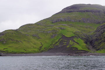 Sailing below the steep and dramatic Vestmanna cliffs in the Atlantic Ocean off the coast of Faroe Islands © ChrisOvergaard