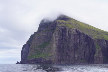 Sailing below the steep and dramatic Vestmanna cliffs in the Atlantic Ocean off the coast of Faroe Islands © ChrisOvergaard