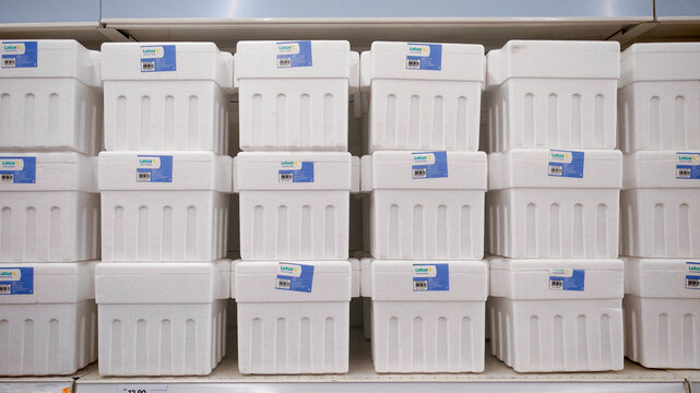 KULIM,MALAYSIA - NOVEMBER 9TH,2025 :Rows of white polystyrene insulated shipping boxes with blue product labels stacked on a store shelf.