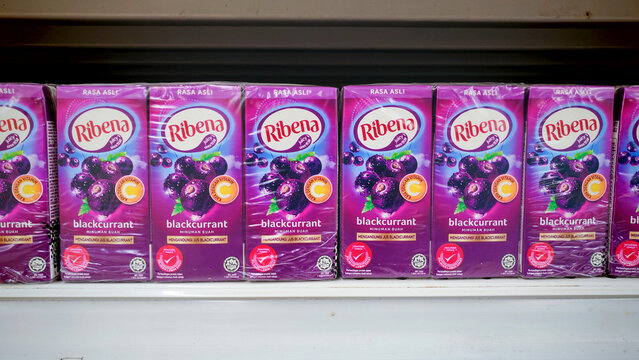 KULIM,MALAYSIA - NOVEMBER 9TH,2025 :Rows of Ribena Blackcurrant juice cartons with bright purple packaging displayed on a supermarket shelf.