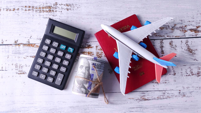 Calculator, Money, Passport, and Airplane: Calculating Travel Budget, Vacation Costs, and International Finance - Powered by Adobe