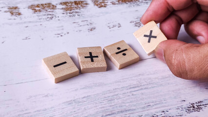 Solving Mathematical Problems: Hand Placing Addition Symbol Tile with Basic Operations