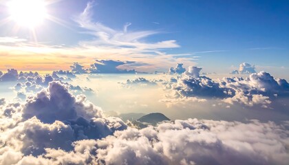 Naklejka premium Ethereal view from above fluffy clouds, sun shining brightly through. Light blue sky fades into the horizon