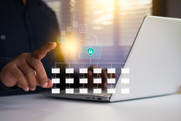 Systematic data storage for easy to use. Folder hierarchy structure and document management system DMS. Businessman using laptop computer for saving and classifying files.