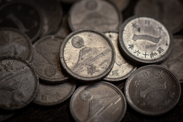 Stack of vintage japanese 1943 one sen coins closeup detail for finance, wealth, currency, historythemed designs, and stock market concepts. © Mr