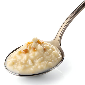 A close up shot of a spoonful of creamy rice pudding with caramel drizzle on a white background