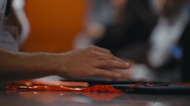 Students Collect Graduation Caps and Gowns from Table Before Ceremony