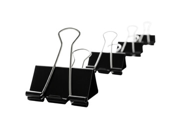 Several black binder clips arranged in a row