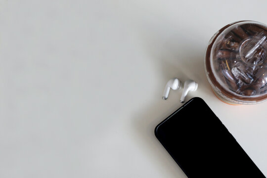 Lifestyle of a relaxing day, drinking coffee and putting down the smartphone with wireless headphones