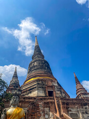 Fototapeta premium Ancient Buddhist Temple with Statues under Blue Sky