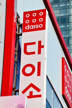 BUSAN, SOUTH KOREA - OCTOBER 9, 2025 - Daiso store sign displaying Hangul text and logo on a building in Busan