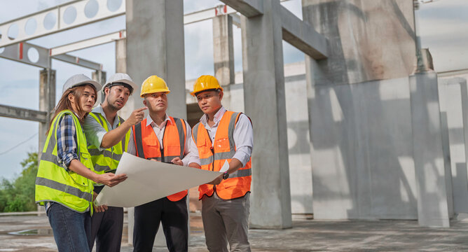 Team of construction engineers and architects discussing blueprint and project details at building site, showcasing teamwork, engineering, infrastructure development, and site planning.
