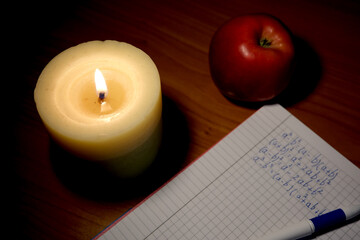 Warm candlelight illuminates a cozy study scene in the evening