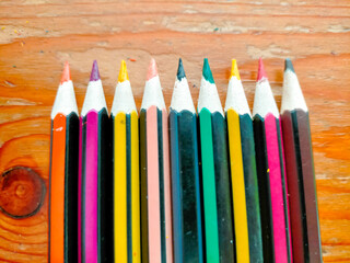 colored pencils on white background
Colored pencils neatly arranged on a wooden table.