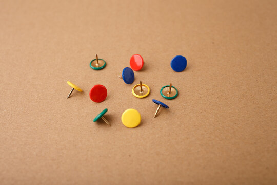 Colorful push pins scattered on cork surface, ideal for education, office supply, planning, school, stationery, DIY, crafting, and organizational business visuals, - Powered by Adobe